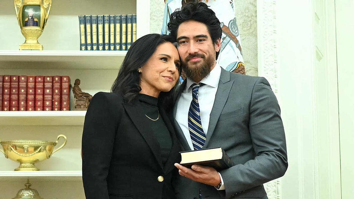 Tulsi Gabbard embraces husband Abraham Williams after swearing-in ceremony.