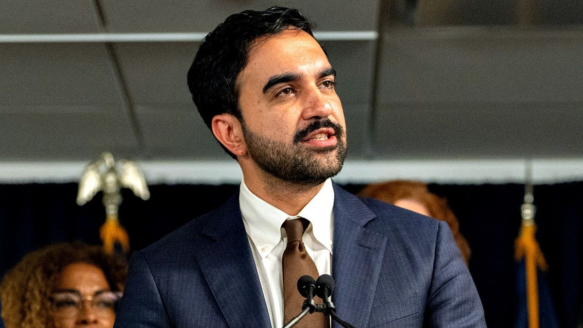 Zohran Mamdani, New York City Mayor, speaks at a podium during an announcement.