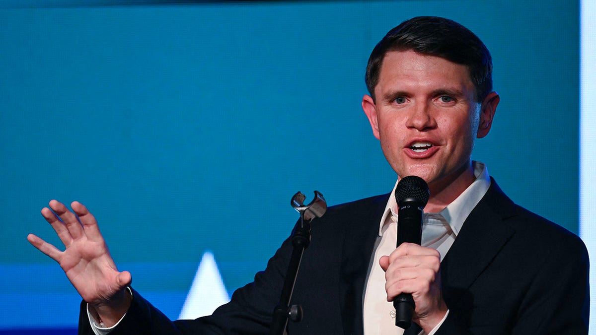 James Talarico speaks into a microphone
