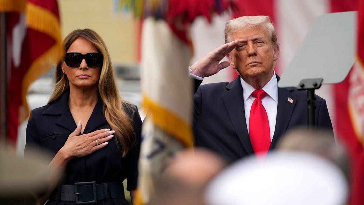 trump saluting next to melania