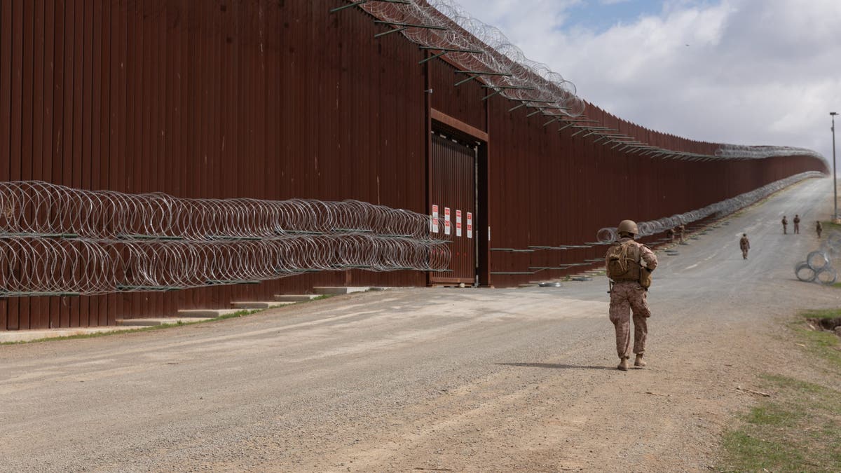 U.S. Marines with 1st Combat Engineer Battalion, 1st Marine Division, affix concertina wire to engineer stakes on the barrier along the southern border near San Ysidro, Calif., Mar. 2, 2025. U.S. Northern Command is working together with the Department of Homeland Security to augment U.S. Customs and Border Protection along the southern border with additional military forces. (U.S. Army photo by Pfc. Dominic Atlas)