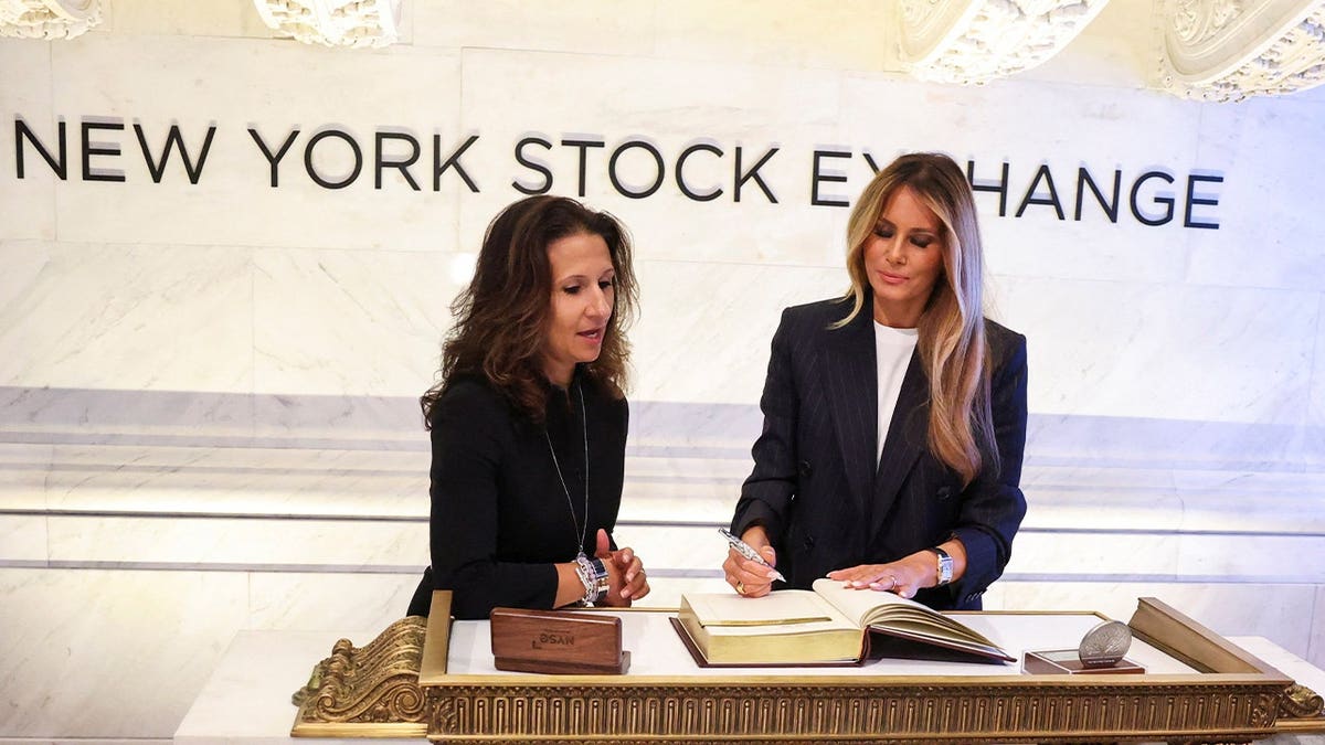 US First Lady Melania Trump, flanked by President of NYSE Group Lynn Martin, signs the New York Stock Exchange (NYSE) guestbook, after ringing the opening bell, in New York City, US, September 23, 2026.