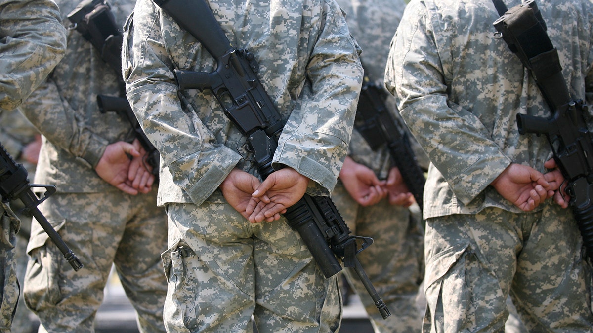 FILE — U.S. soldiers take part in a military ceremony. The proposed base, dubbed the "Next Great American Base," would house up to 25,000 service members.