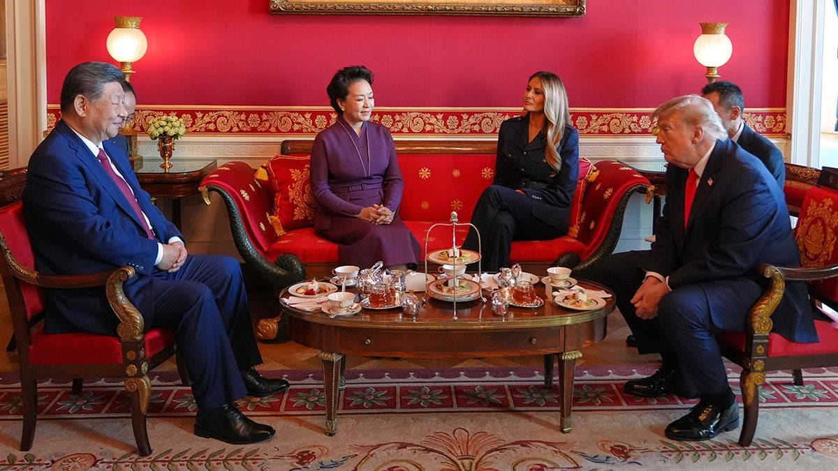 President Donald Trump and first lady Melania Trump stand with China's President Xi Jinping and his wife Peng Liyuan in the Red Room.