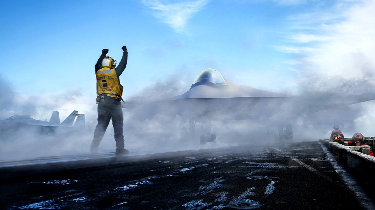 Artist’s rendering of a Boeing F/A-XX fighter on an aircraft carrier deck as a crew member signals nearby