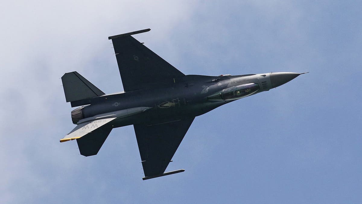 U.S. Air Force F-16 Fighting Falcon jet maneuvers during aerobatic display in Singapore.