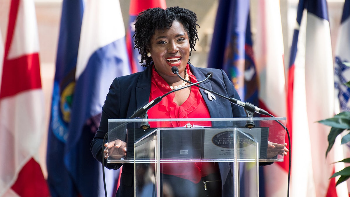 Joanna McClinton speaks at a podium