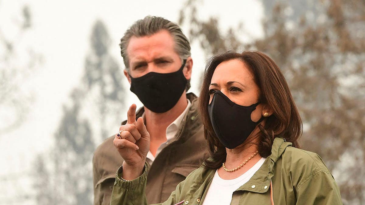 Kamala Harris and Gavin Newsom stand outdoors at Pine Ridge Elementary School in Fresno, Calif.