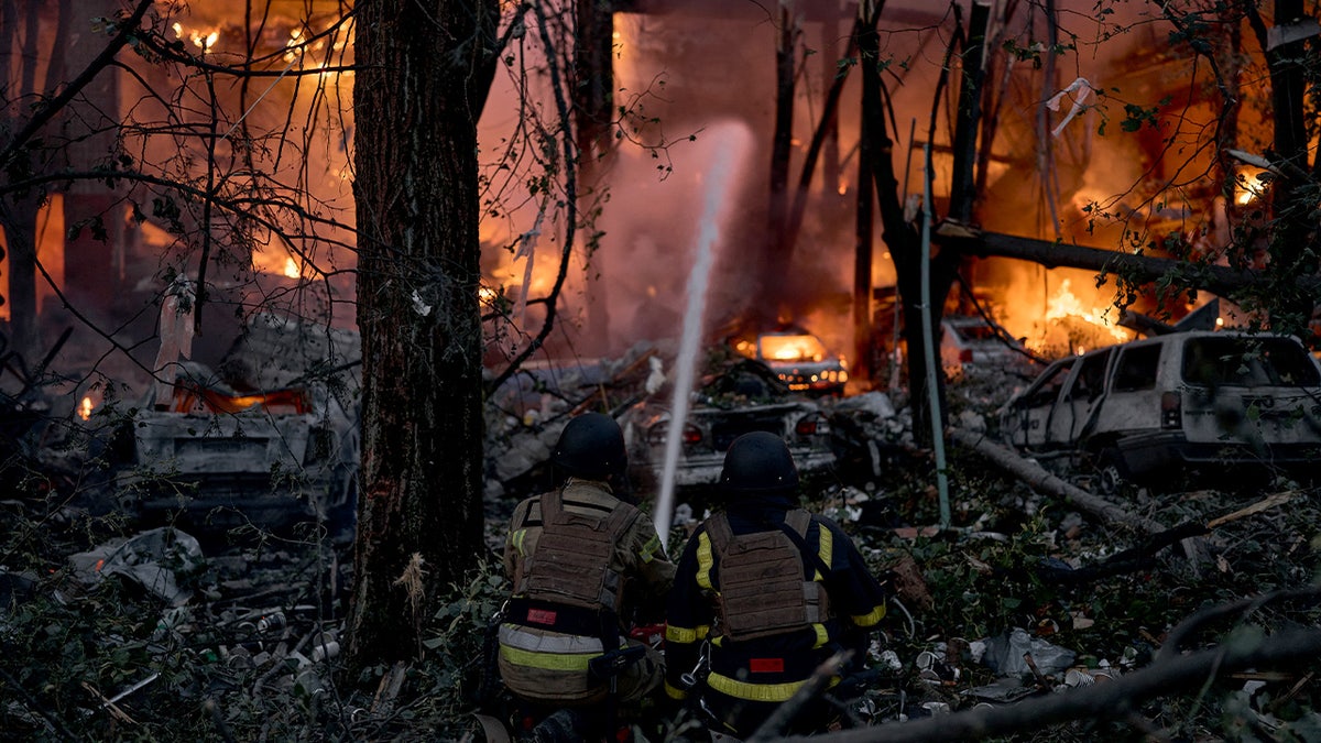 Rescue workers respond to a Russian drone and missile attack on Kyiv.