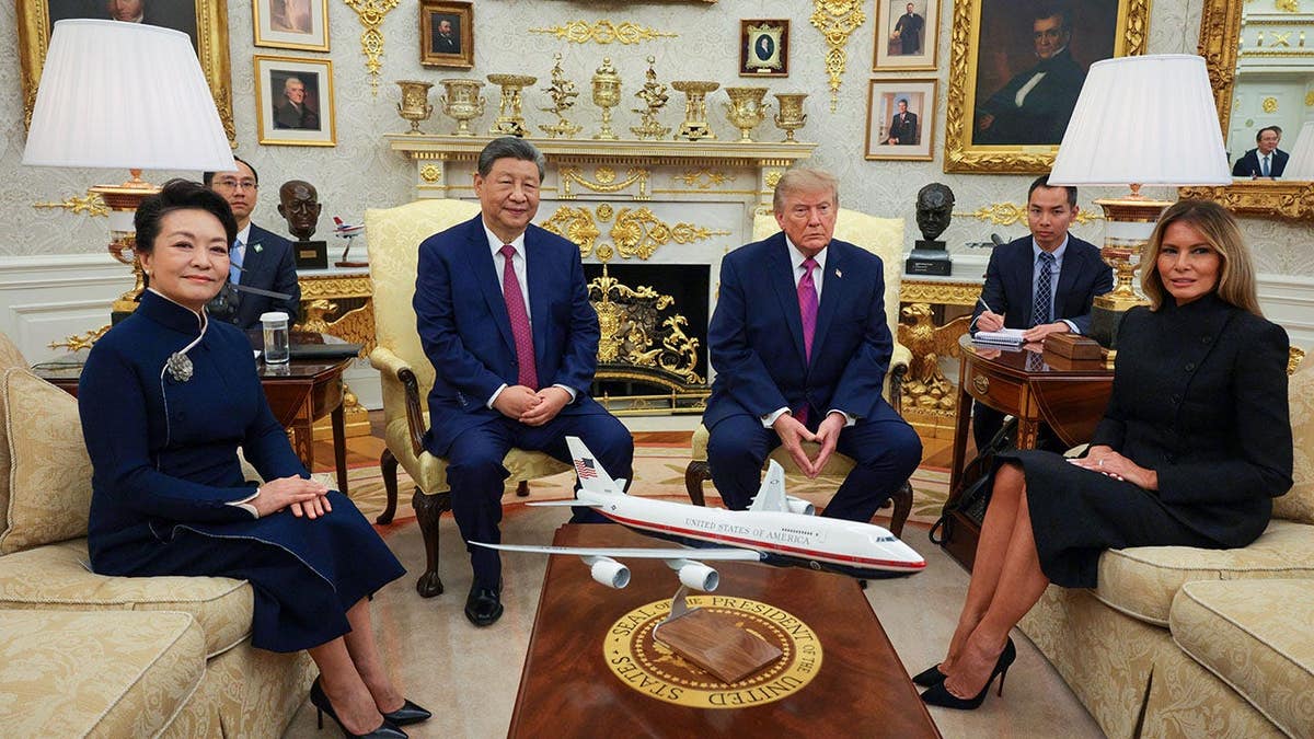 Xi Jinping and Peng Liyuan sit with President Trump and Melania Trump in the Oval Office.