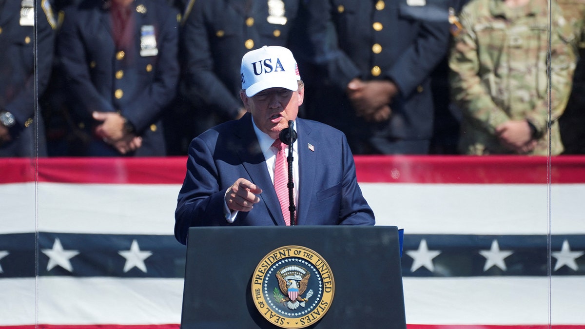 U.S. President Donald Trump speaks, while standing behind protective glass, during the Steel Across America event featuring a 21-foot steel beam recovered from the World Trade Centre South Tower, on the Ellipse near the White House in Washington, D.C., U.S., September 8, 2026.