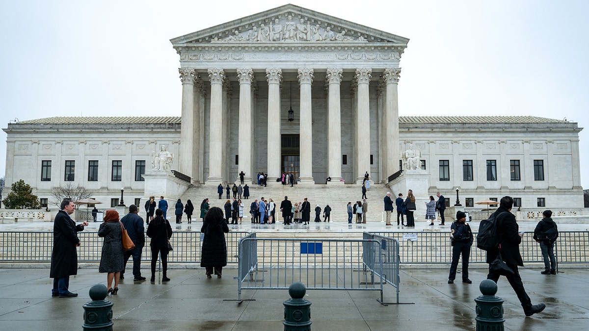 People gather outside of Supreme Court building in Washington