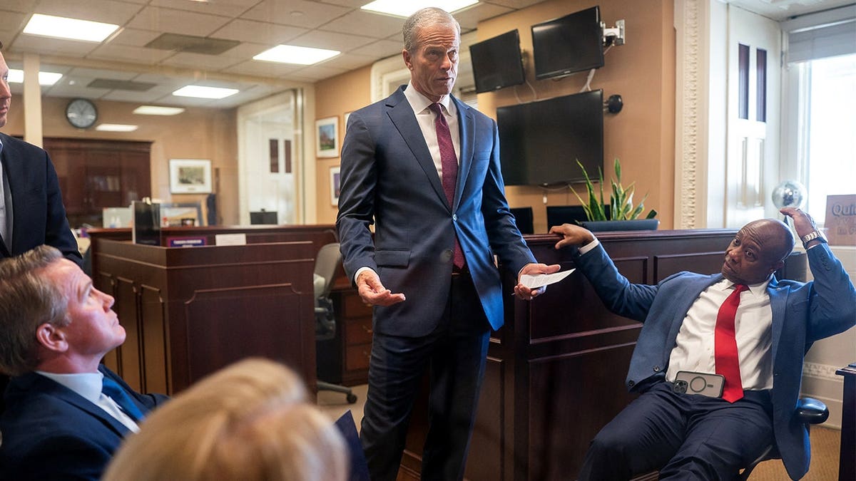 U.S. Senate Majority Leader John Thune , R-SD, speaks with Senator Tim Scott R-S.C., and Senator Jon Husted R-Ohio, ahead of a press conference on the 