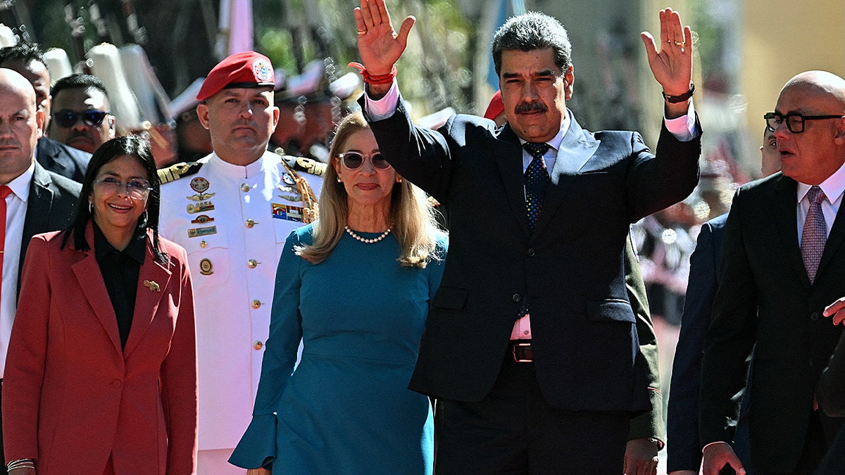 Venezuela's President Nicolas Maduro (2nd R) waves next to First Lady Cilia Flores, Vice President Delcy Rodriguez