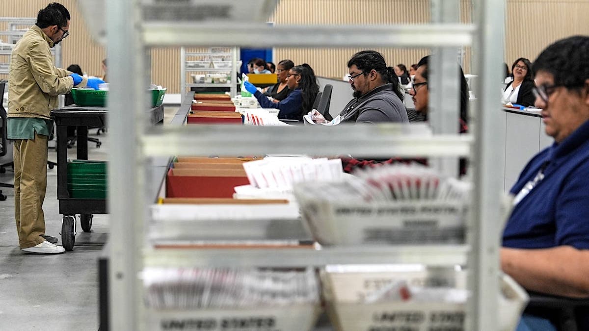 election workers process mail-in ballots