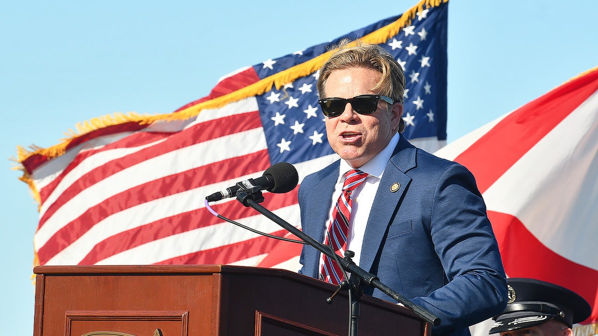 Rep. Mike Haridopolos stands in front of an American flag