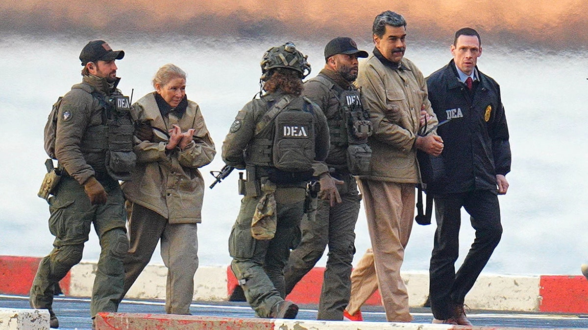 Nicolas Maduro and his wife Cilia Flores escorted by federal agents