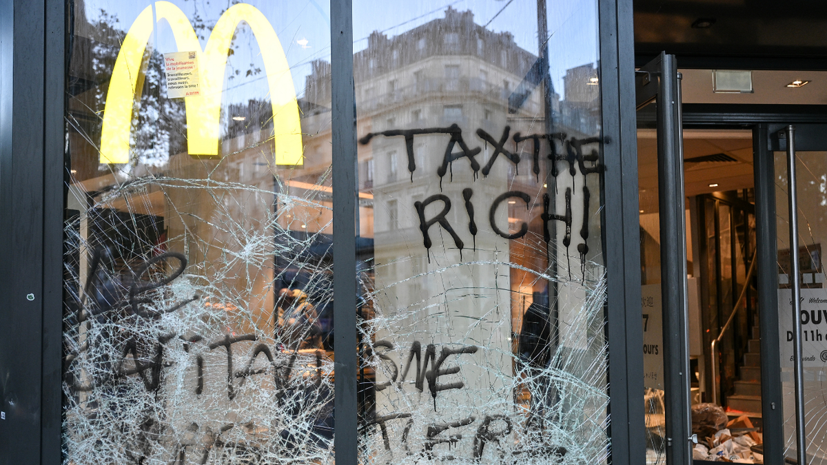 The entrance of a McDonald's fast food restaurant covered in graffiti and damaged a day after nationwide protests against the