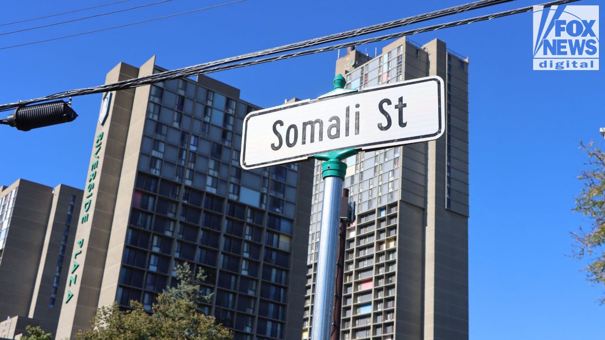 Somali Street sign with Riverside Plaza buildings behind it in Minneapolis