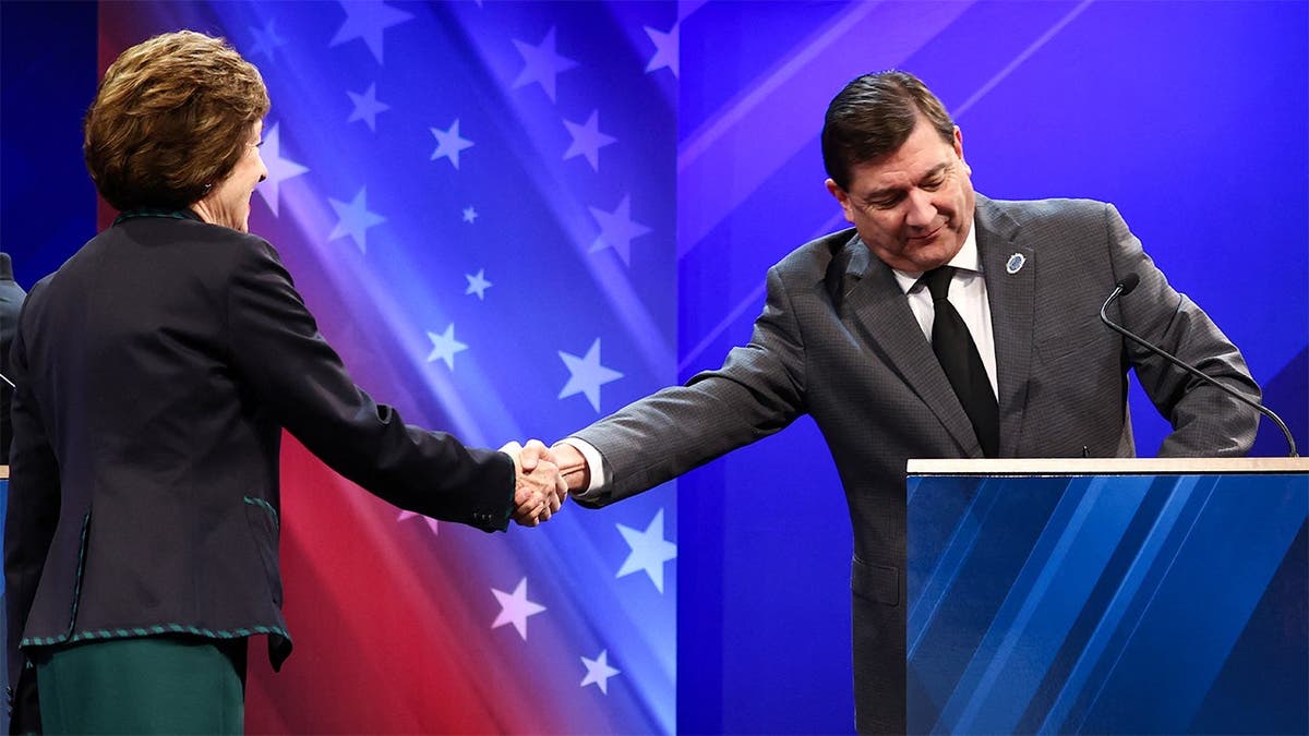 Susan Collins, right, shakes hands with Troy Jackson as the two arrived at Thursday's debate