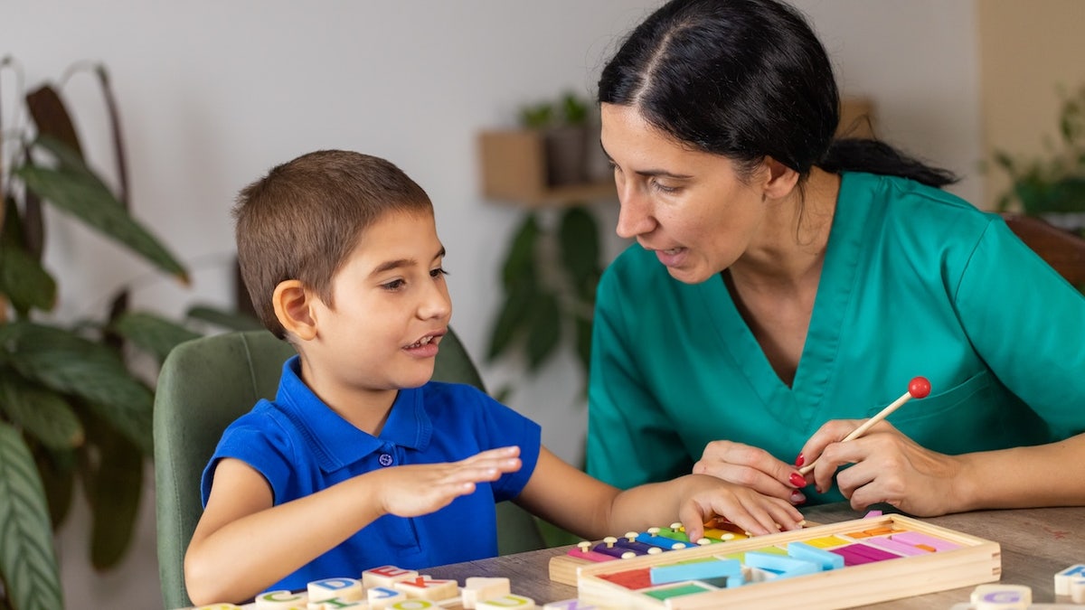 Therapist with a boy with autism