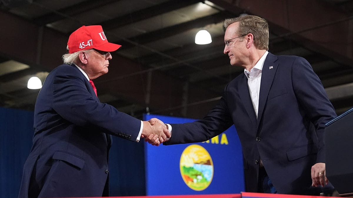 President Donald Trump shakes hands with Senate candidate Kurt Alme.