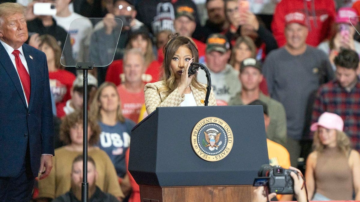 Rapper Nicki Minaj speaks onstage with President Donald Trump during a midterm rally