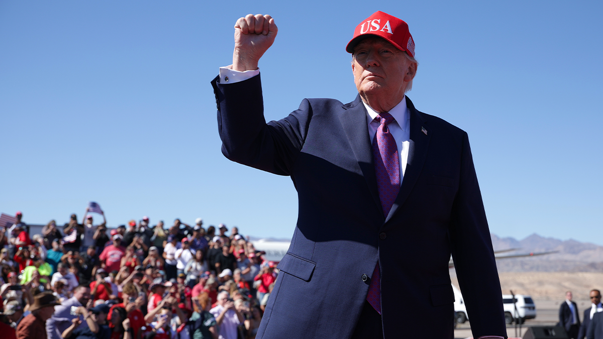 President Donald Trump raises his fist in front of supporters at his Bullhead City, Arizona, rally