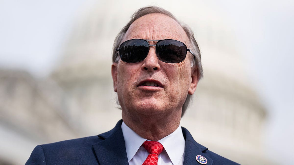 Rep. Andy Biggs wearing sunglasses with the background of the U.S. Capitol behind him
