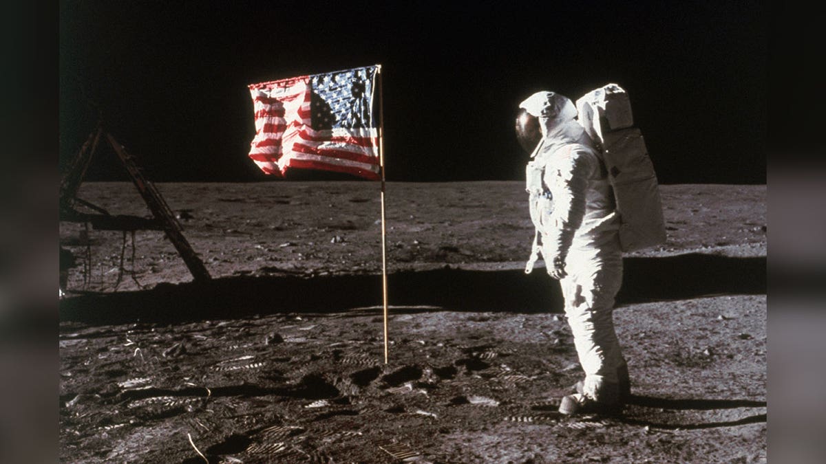 Astronaut Buzz Aldrin next to U.S. flag on moon