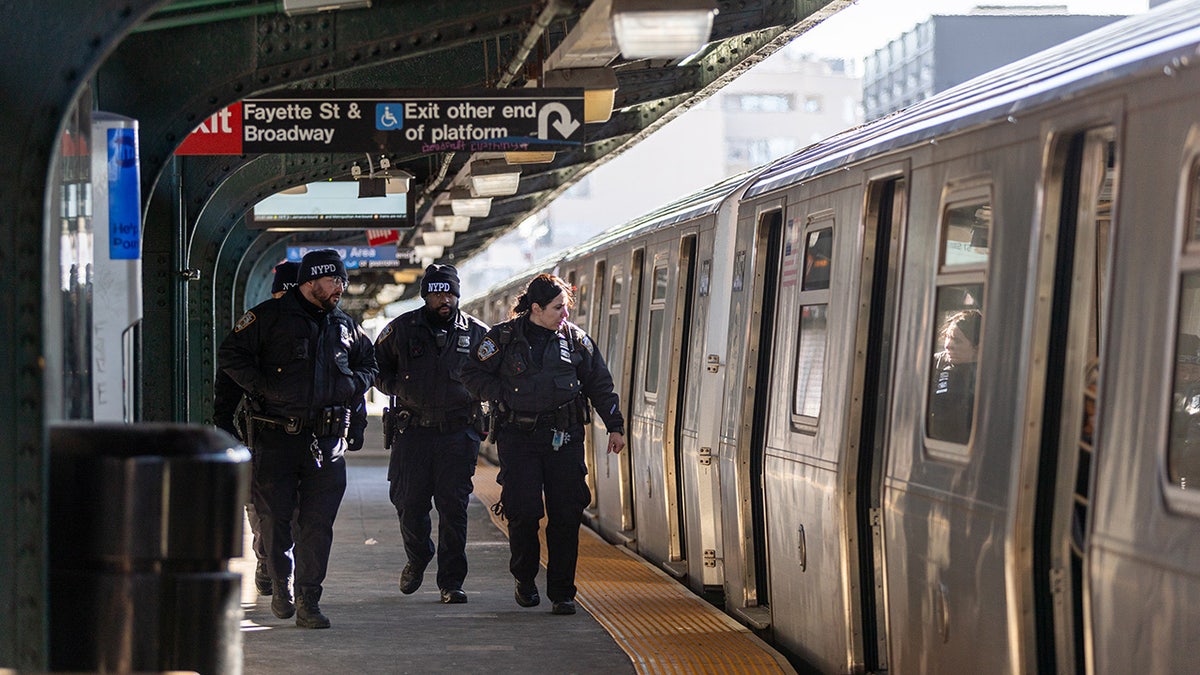 NYPD officers patrol subway platform