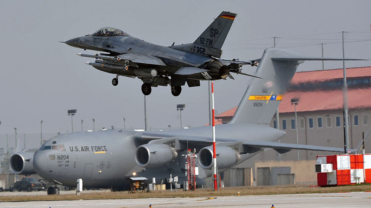 F-16 in front of a C-17 at Aviano Air Base